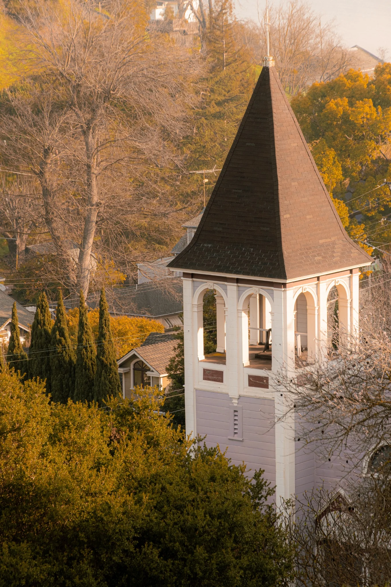 A historic church tower lit by warm evening light