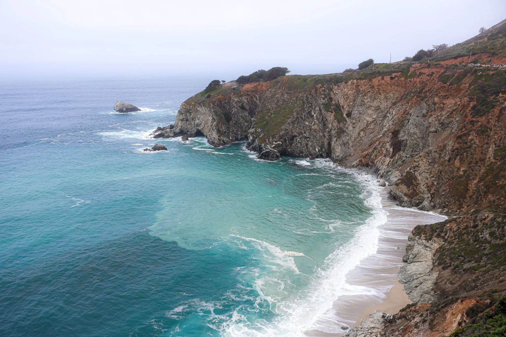 Turquoise ocean meeting a rugged California cove