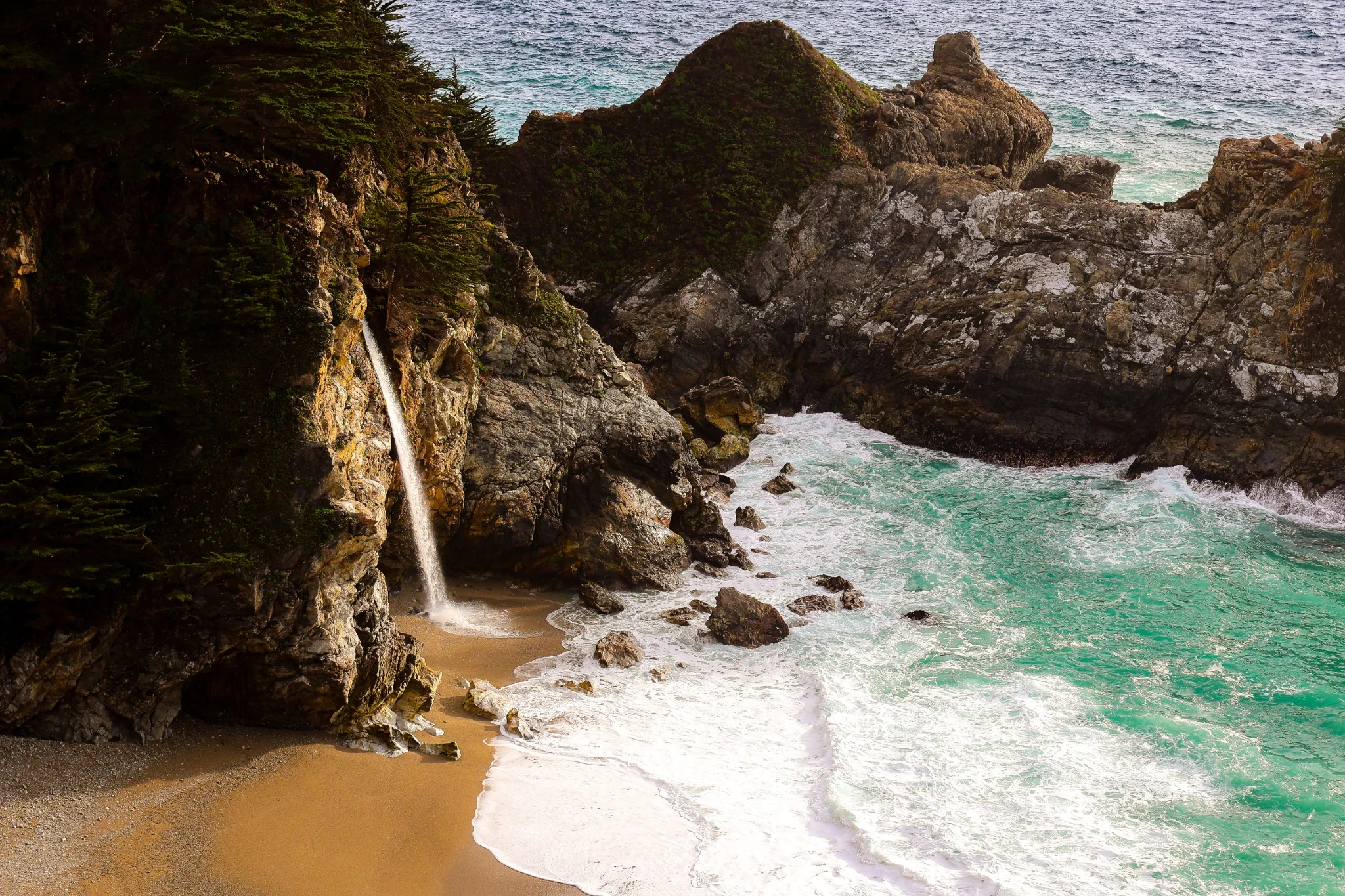 McWay Falls descending from a Big Sur cliff toward the Pacific Ocean